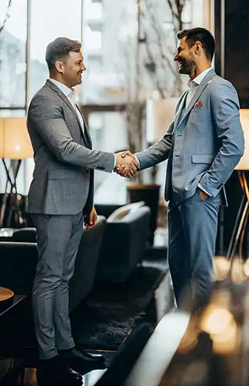 Two men in suits shaking hands
